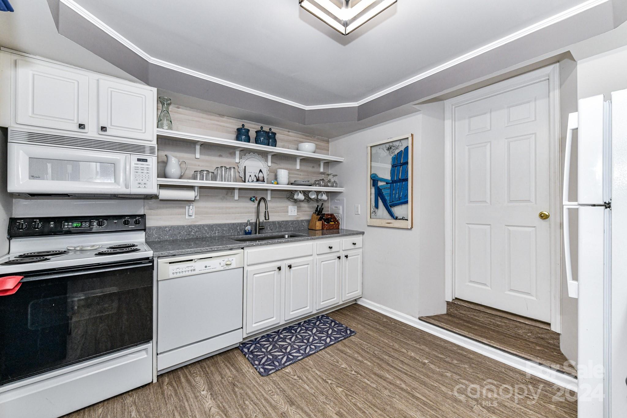 334 Ervin Road Mooresville, NC 28117 - Photo 28 of 48 a kitchen with stainless steel appliances granite countertop a stove and a sink