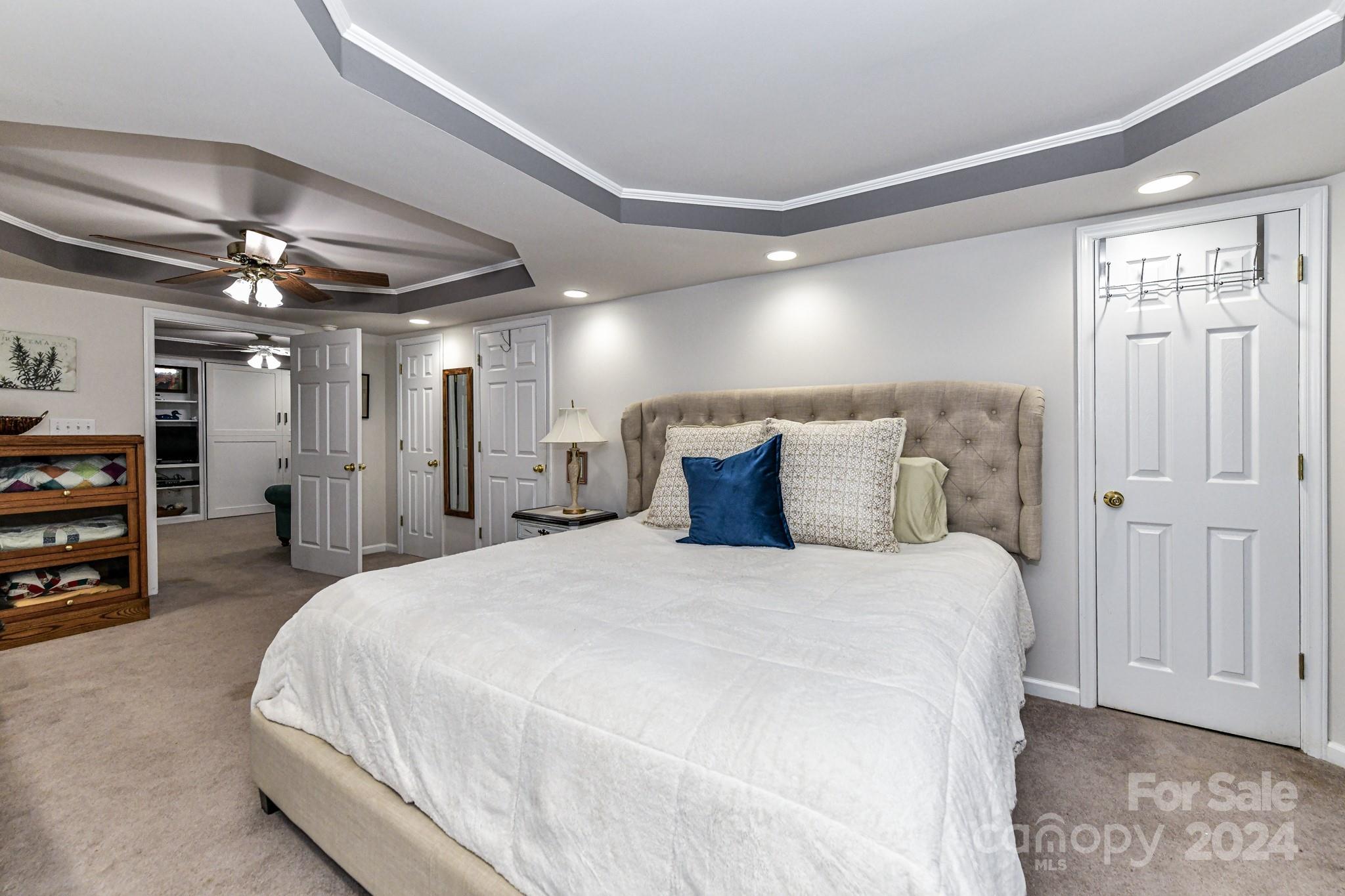 334 Ervin Road Mooresville, NC 28117 - Photo 30 of 48 a bedroom with a bed and a chandelier