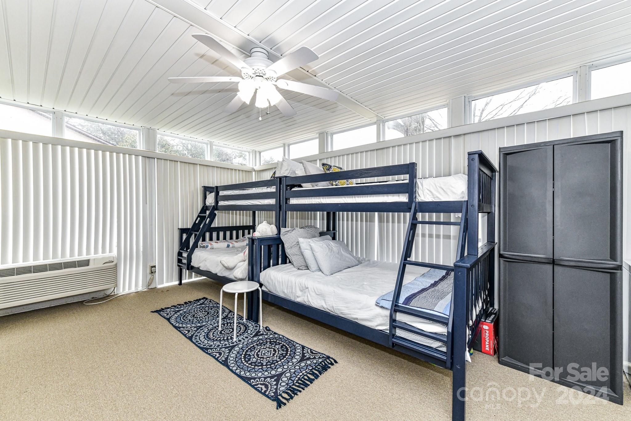 334 Ervin Road Mooresville, NC 28117 - Photo 32 of 48 a bedroom with furniture and a chandelier