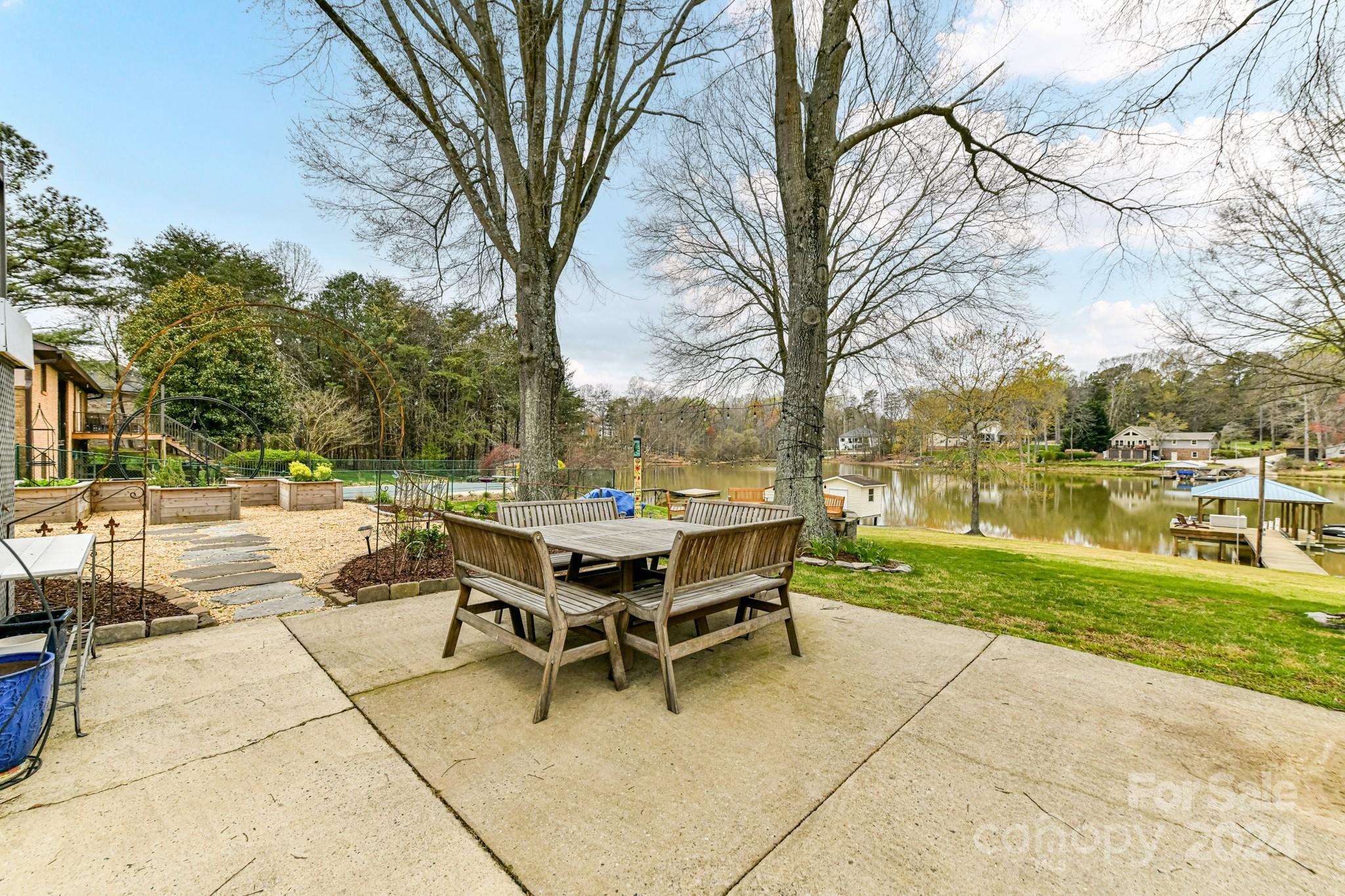 334 Ervin Road Mooresville, NC 28117 - Photo 39 of 48 a view of a patio with dining table and chairs with wooden fence and floor