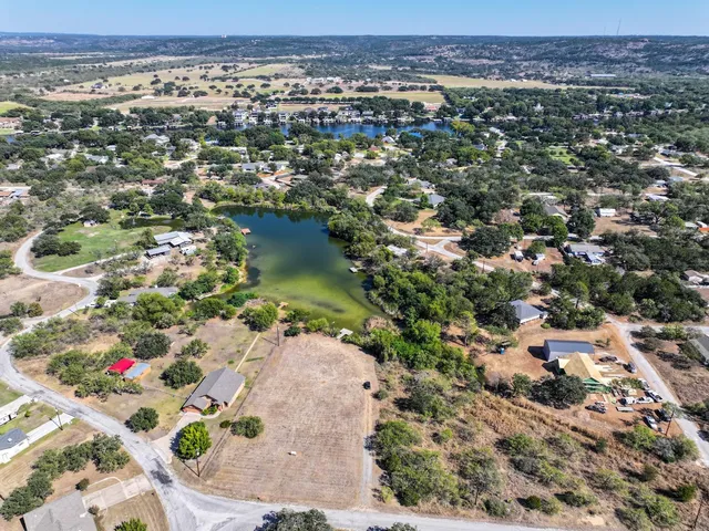 an aerial view of a houses with a lake view