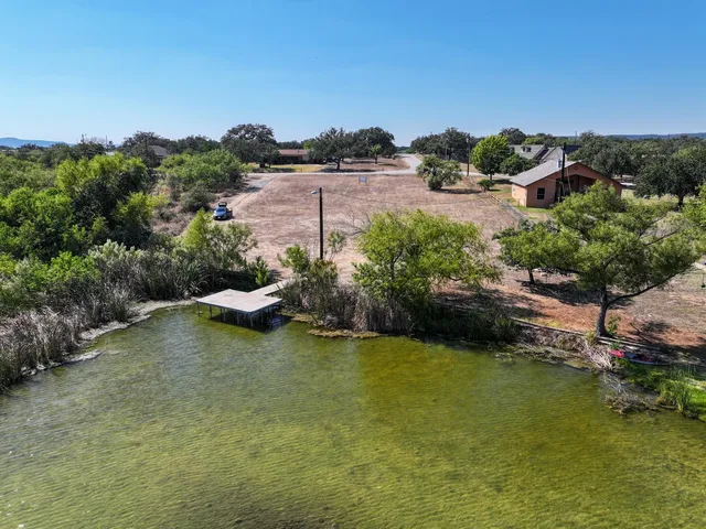 an aerial view of a houses with a lake view