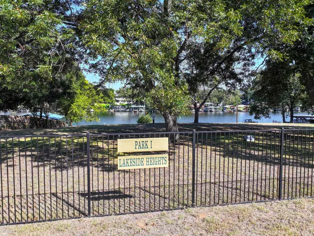 an aerial view of ocean and residential houses with outdoor space