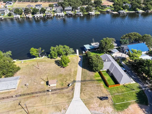 an aerial view of a houses with a lake view