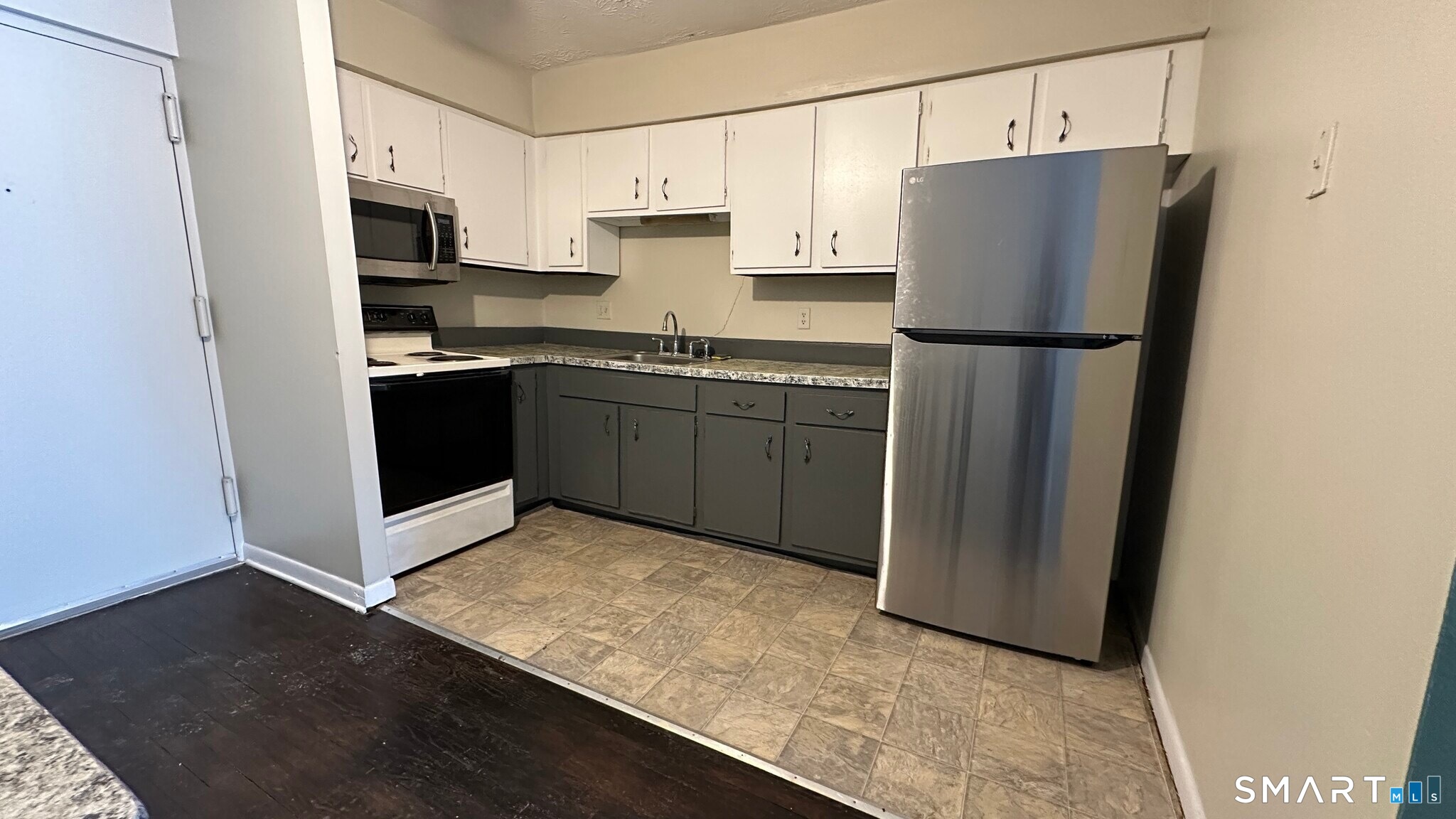 581 Crown Street, Unit 99 Meriden, CT 06450 - Photo 1 of 10 a kitchen with stainless steel appliances granite countertop a refrigerator a stove a sink and a microwave