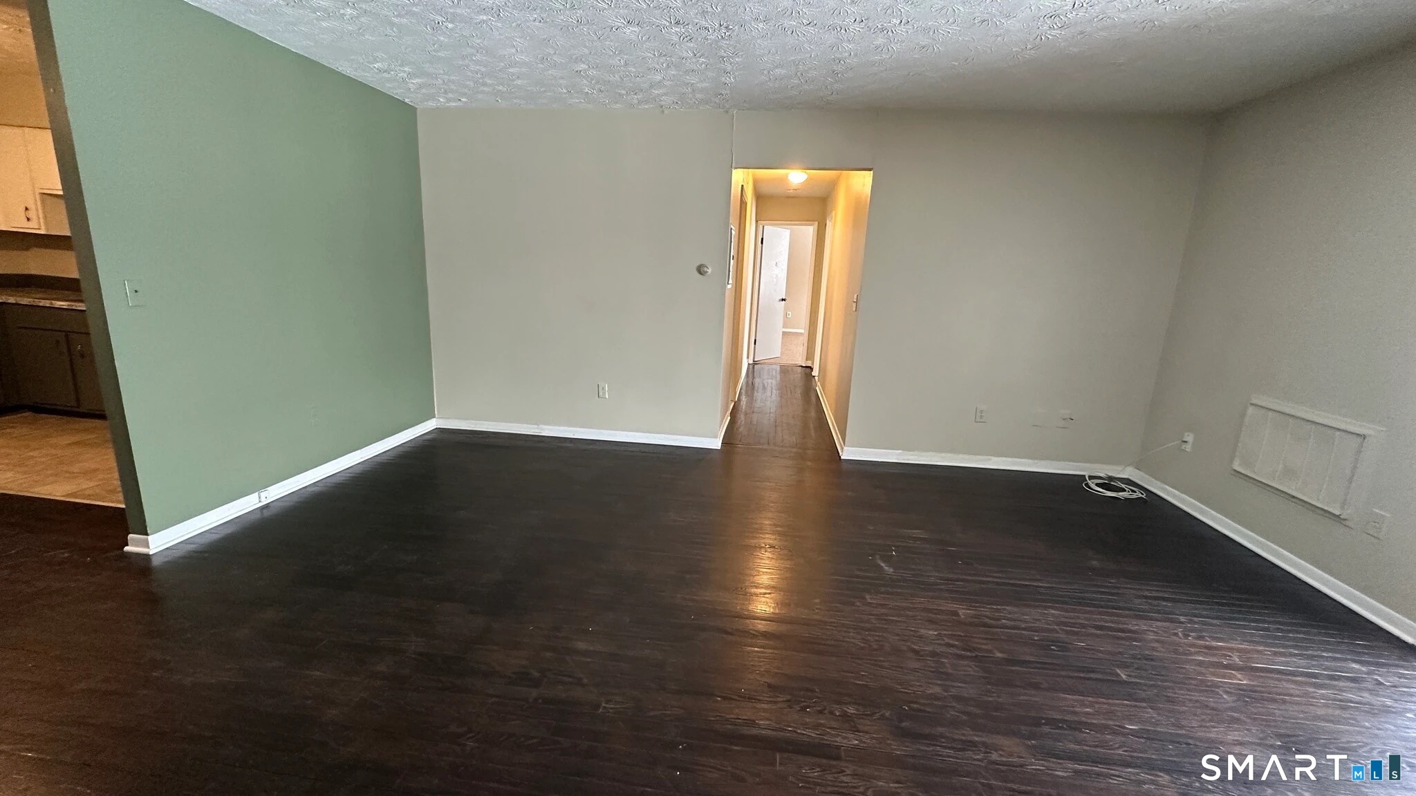 581 Crown Street, Unit 99 Meriden, CT 06450 - Photo 7 of 10 an empty room with wooden floor and windows