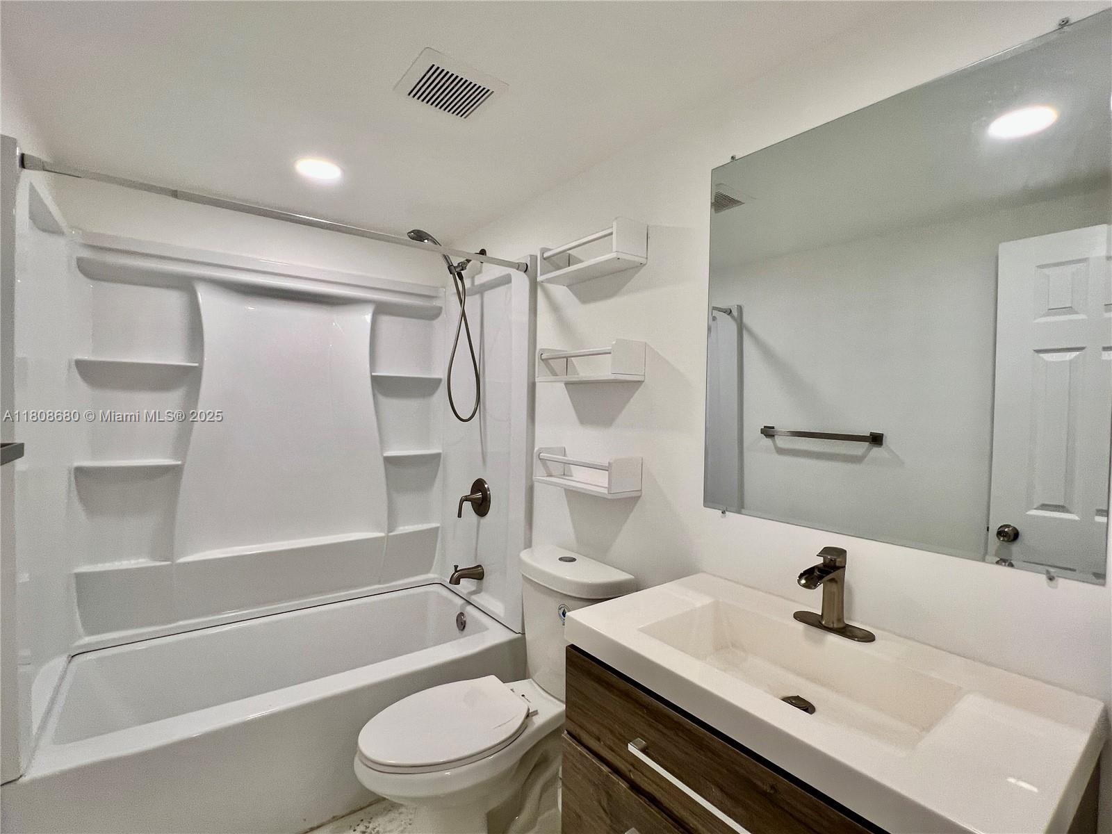 2005 Sans Souci Boulevard, Unit 202 North Miami, FL 33181 - Photo 12 of 13 a bathroom with a sink toilet and shower