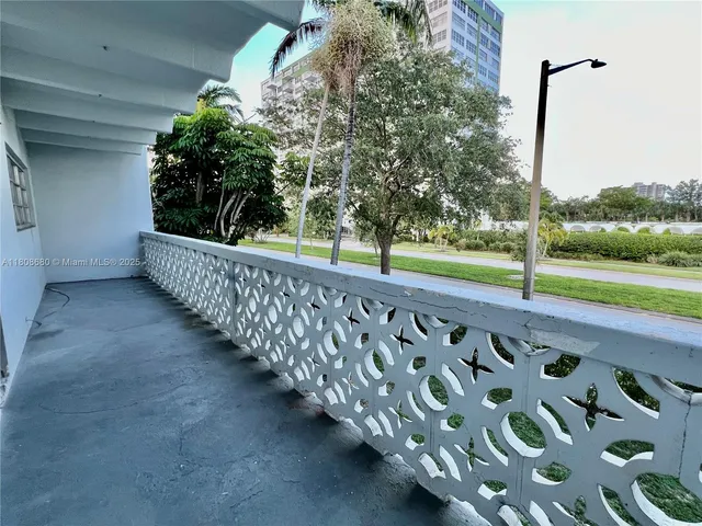 a view of a yard with wooden fence