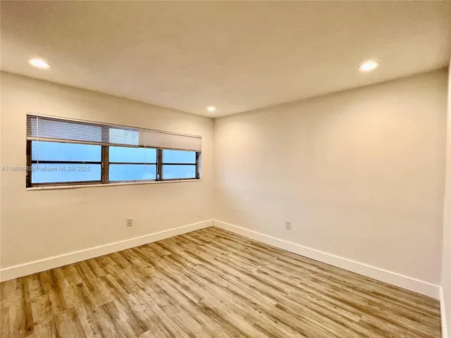 a view of a room with wooden floor and fence