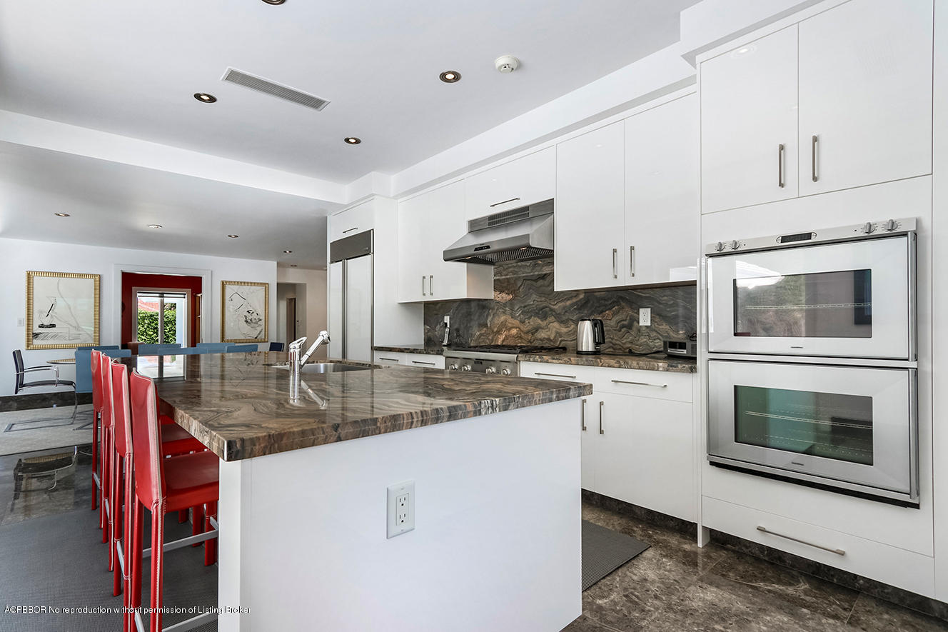 75 Spoonbill Road Manalapan, FL 33462 - Photo 11 of 41 a kitchen with stainless steel appliances granite countertop a stove top oven a sink a counter space and cabinets