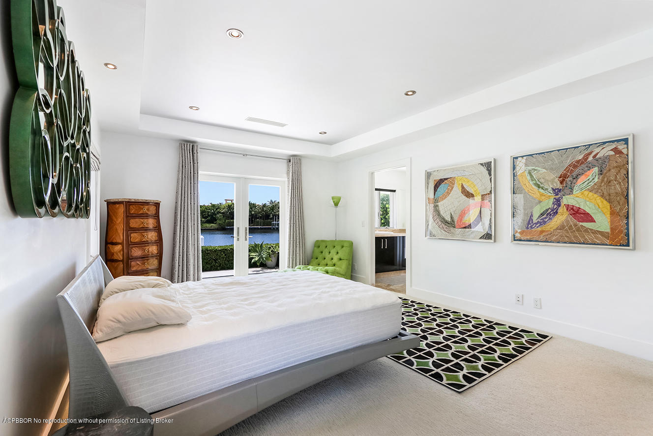 75 Spoonbill Road Manalapan, FL 33462 - Photo 13 of 41 a bedroom with a bed painting on wall and a large window