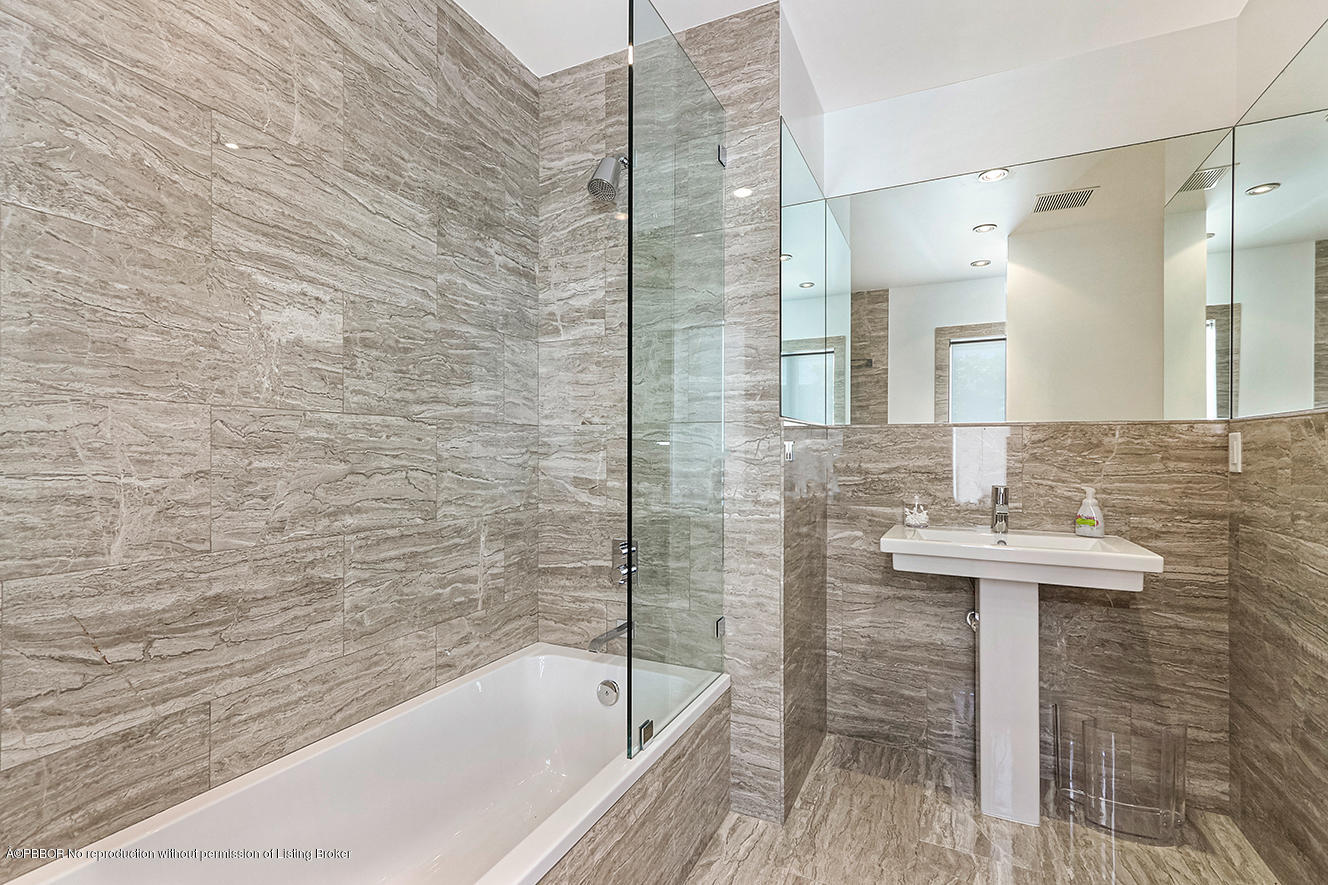 75 Spoonbill Road Manalapan, FL 33462 - Photo 15 of 41 a bathroom with a sink and a bathtub