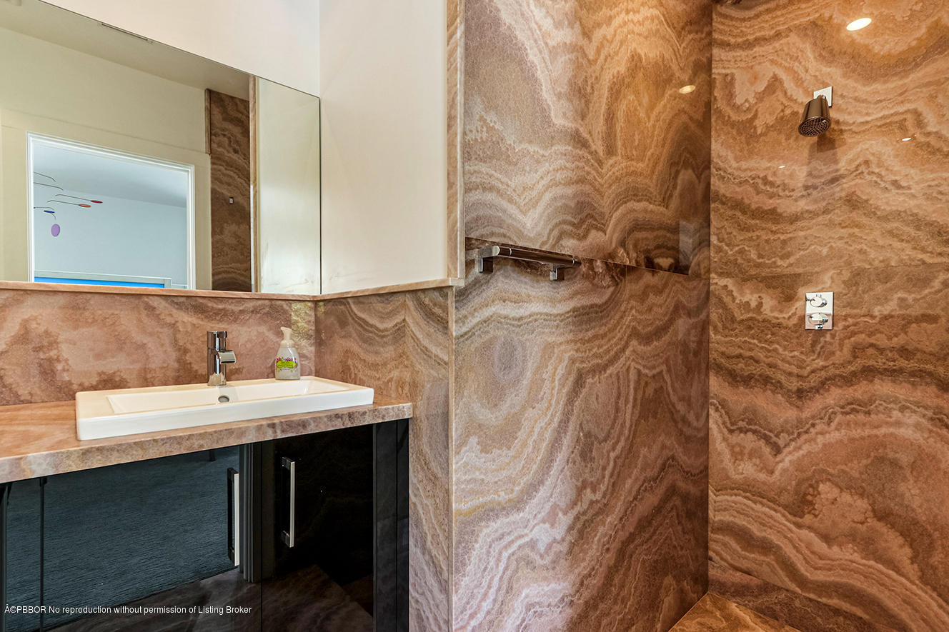 75 Spoonbill Road Manalapan, FL 33462 - Photo 16 of 41 a bathroom with a sink and mirror