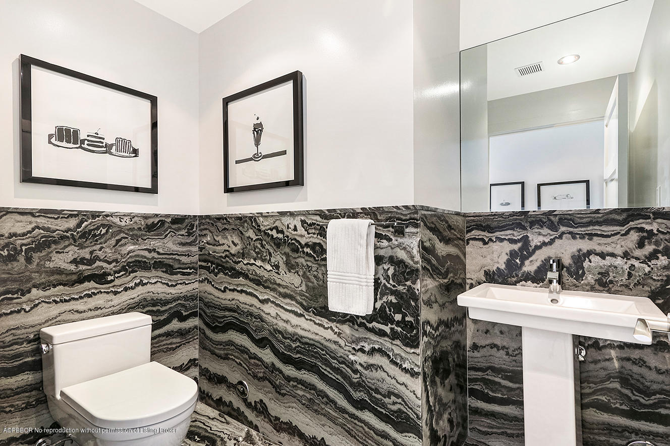 75 Spoonbill Road Manalapan, FL 33462 - Photo 17 of 41 a bathroom with a sink toilet and mirror