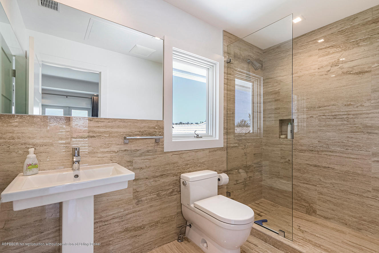 75 Spoonbill Road Manalapan, FL 33462 - Photo 20 of 41 a bathroom with a sink a toilet and shower