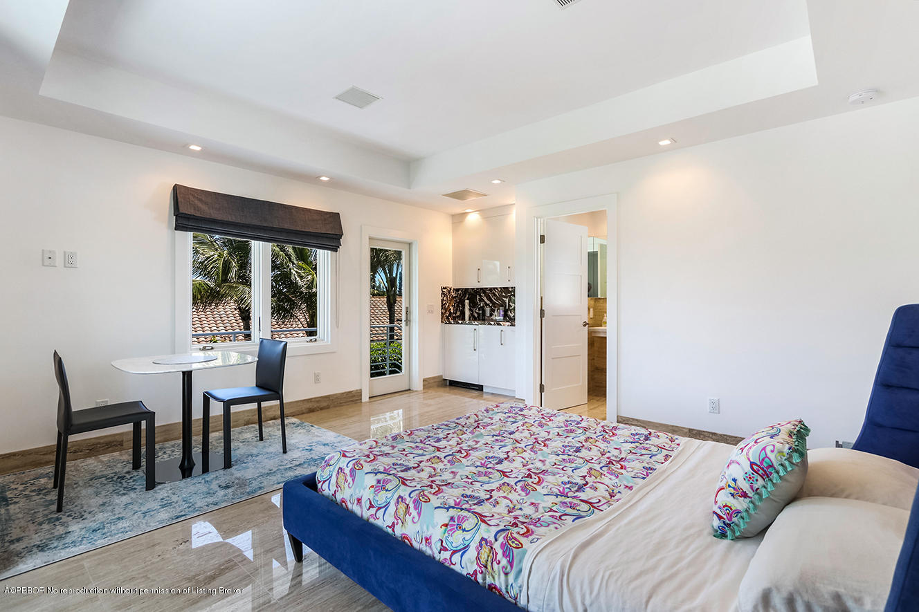 75 Spoonbill Road Manalapan, FL 33462 - Photo 31 of 41 a bedroom with a bed and a table in it