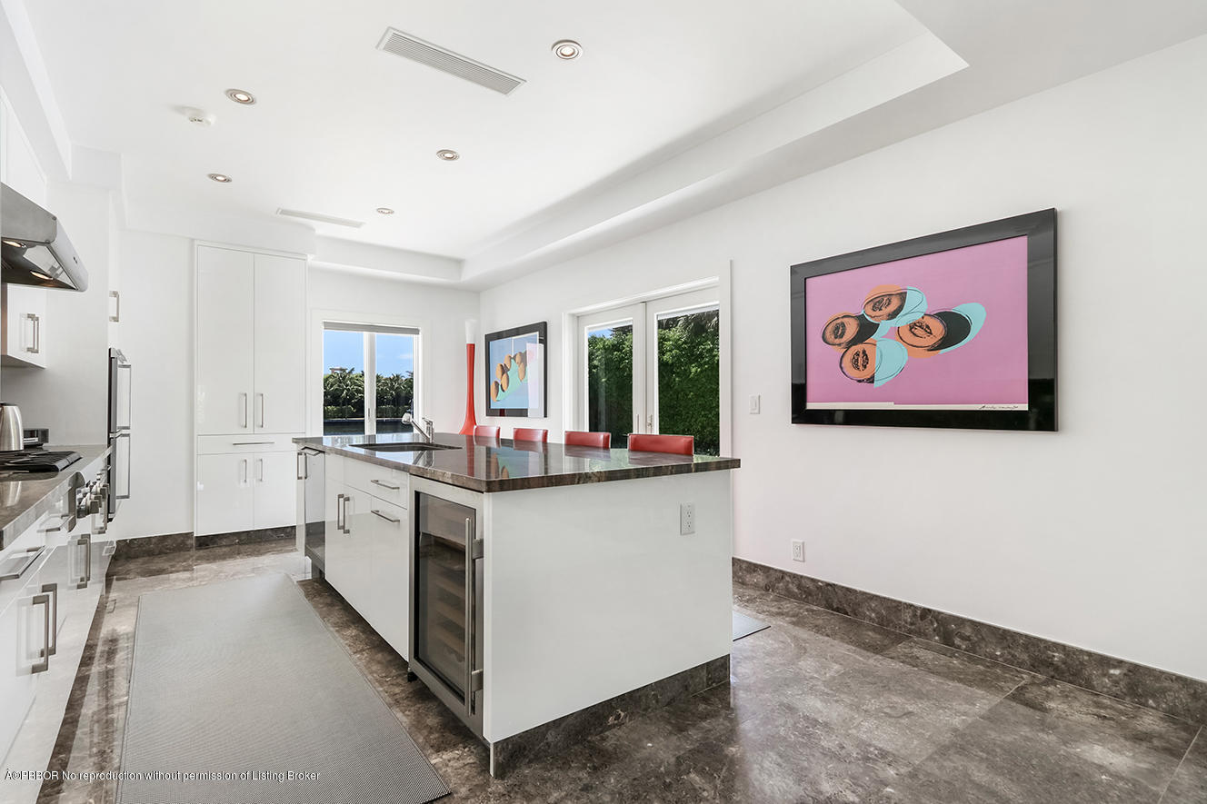 75 Spoonbill Road Manalapan, FL 33462 - Photo 35 of 41 a large white kitchen with stainless steel appliances granite countertop a stove and a large window