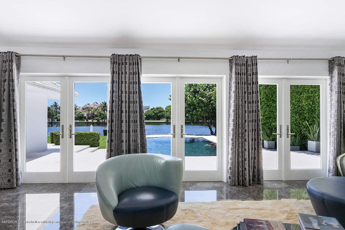 75 Spoonbill Road Manalapan, FL 33462 - Photo 9 of 41 a living room with furniture and a floor to ceiling window