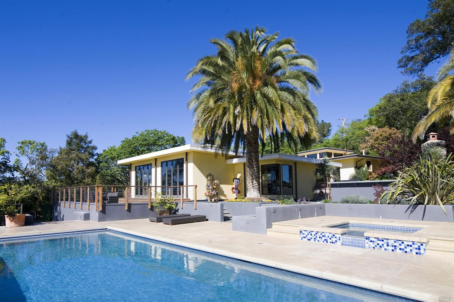 a front view of a house with swimming pool and porch