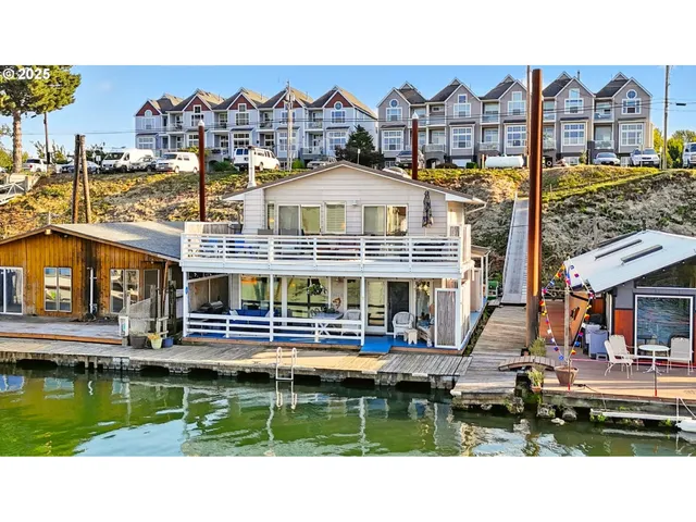 a front view of a house with swimming pool having outdoor seating