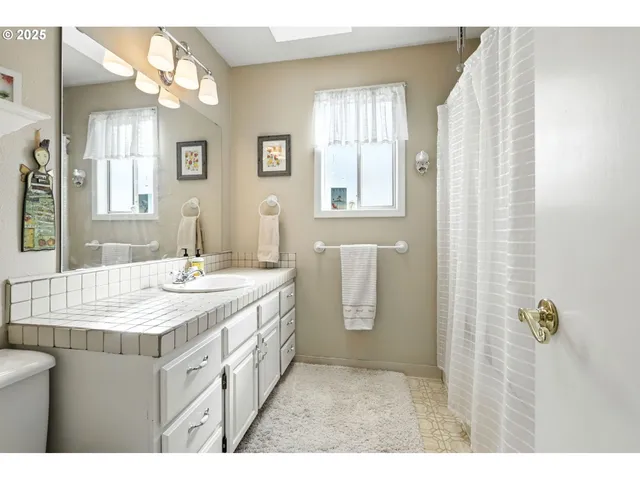 a bathroom with a sink a mirror and a shower