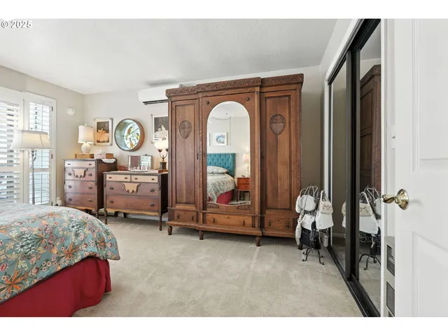 a living room with furniture and a large mirror