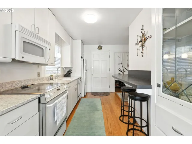 a kitchen with stainless steel appliances kitchen island granite countertop a sink and cabinets
