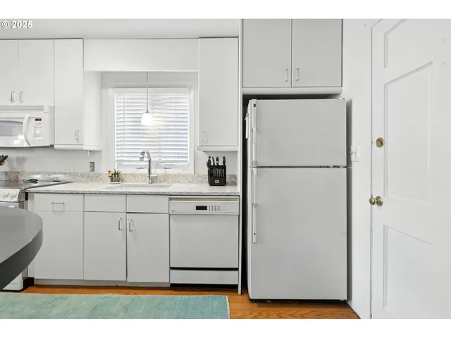 a white refrigerator freezer sitting inside of a kitchen