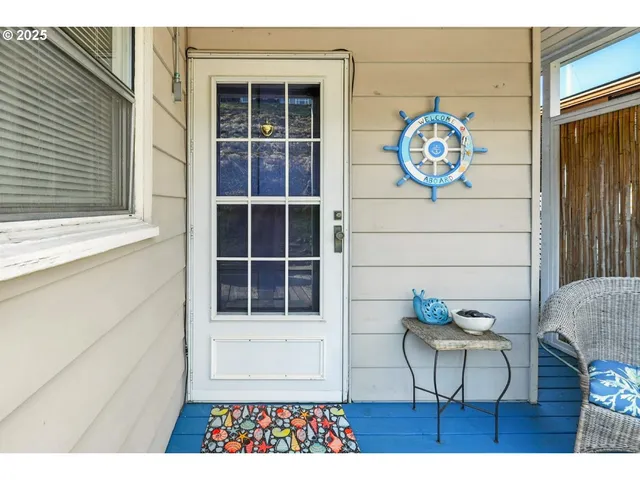 a view of a door and chair in wooden floor