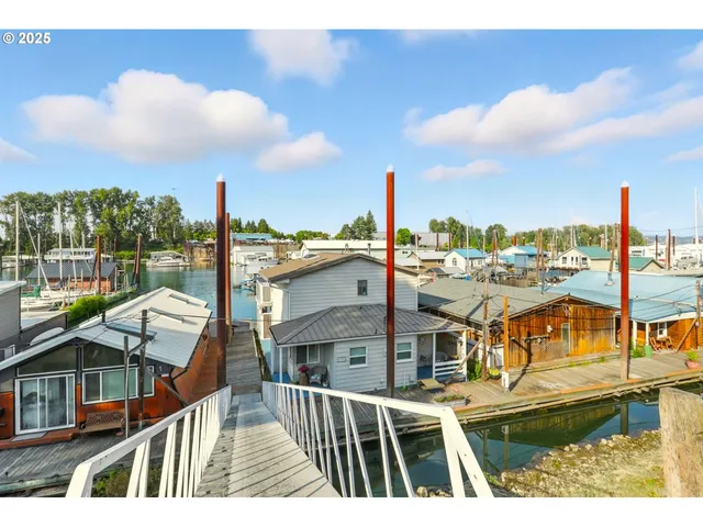 a aerial view of a house with a garden and lake view