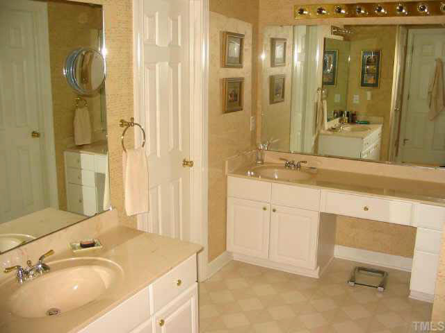 9016 Breeland Way Raleigh, NC 27613 - Photo 7 of 10 a bathroom with a sink and a mirror