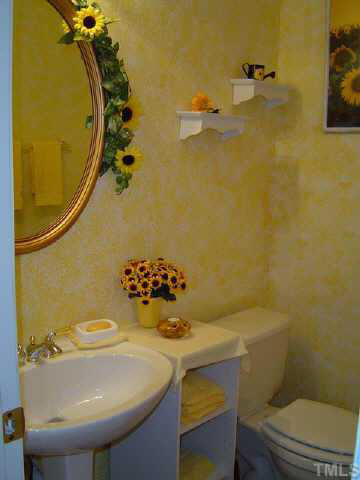 9016 Breeland Way Raleigh, NC 27613 - Photo 10 of 10 a bathroom with a sink mirror vanity and toilet