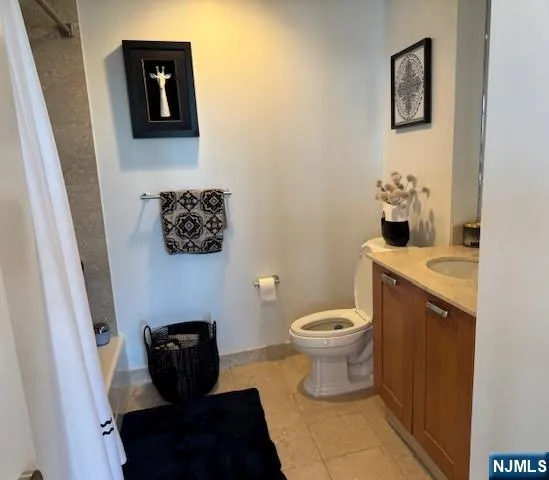a bathroom with a toilet and a shower curtain