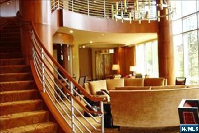 a view of staircase with lots of frames on wall and windows