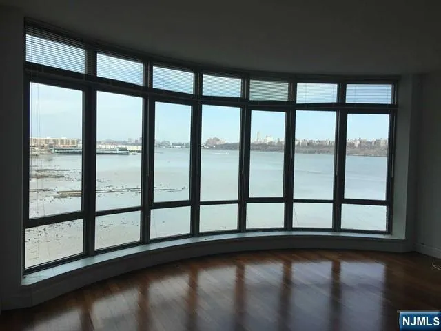 a view of empty room with floor to ceiling windows