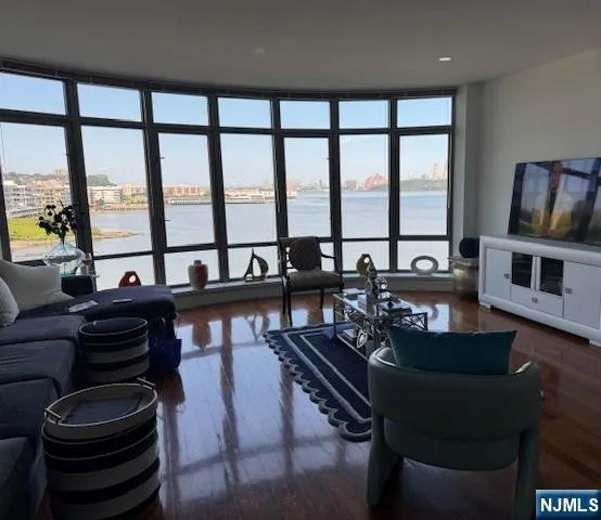 a living room with furniture and floor to ceiling windows