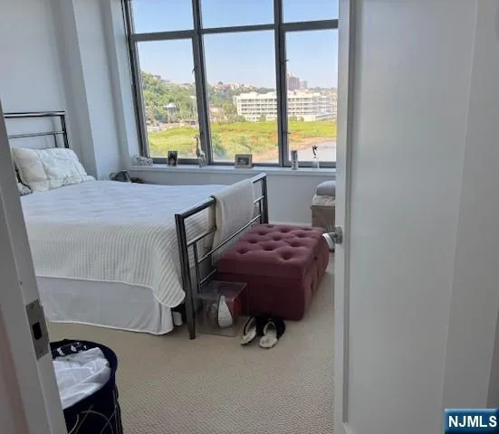 a bedroom with a bed and large window