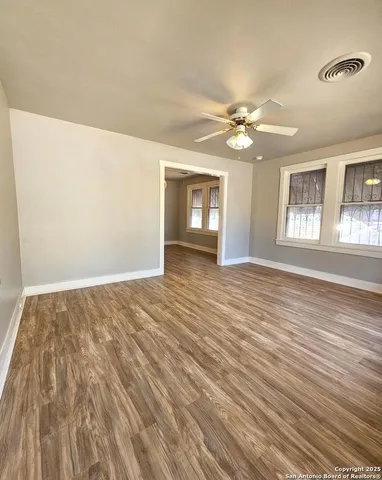 wooden floor in an empty room with a window