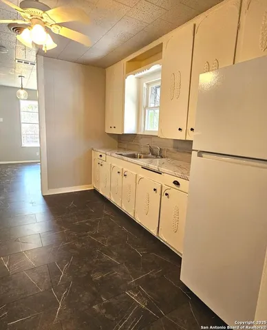 a bathroom with a sink a mirror and a shower