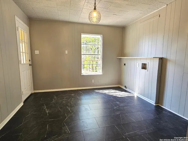 an empty room with windows and entrance