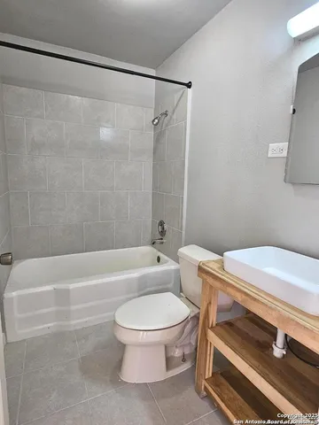 a bathroom with a sink a toilet and a bathtub