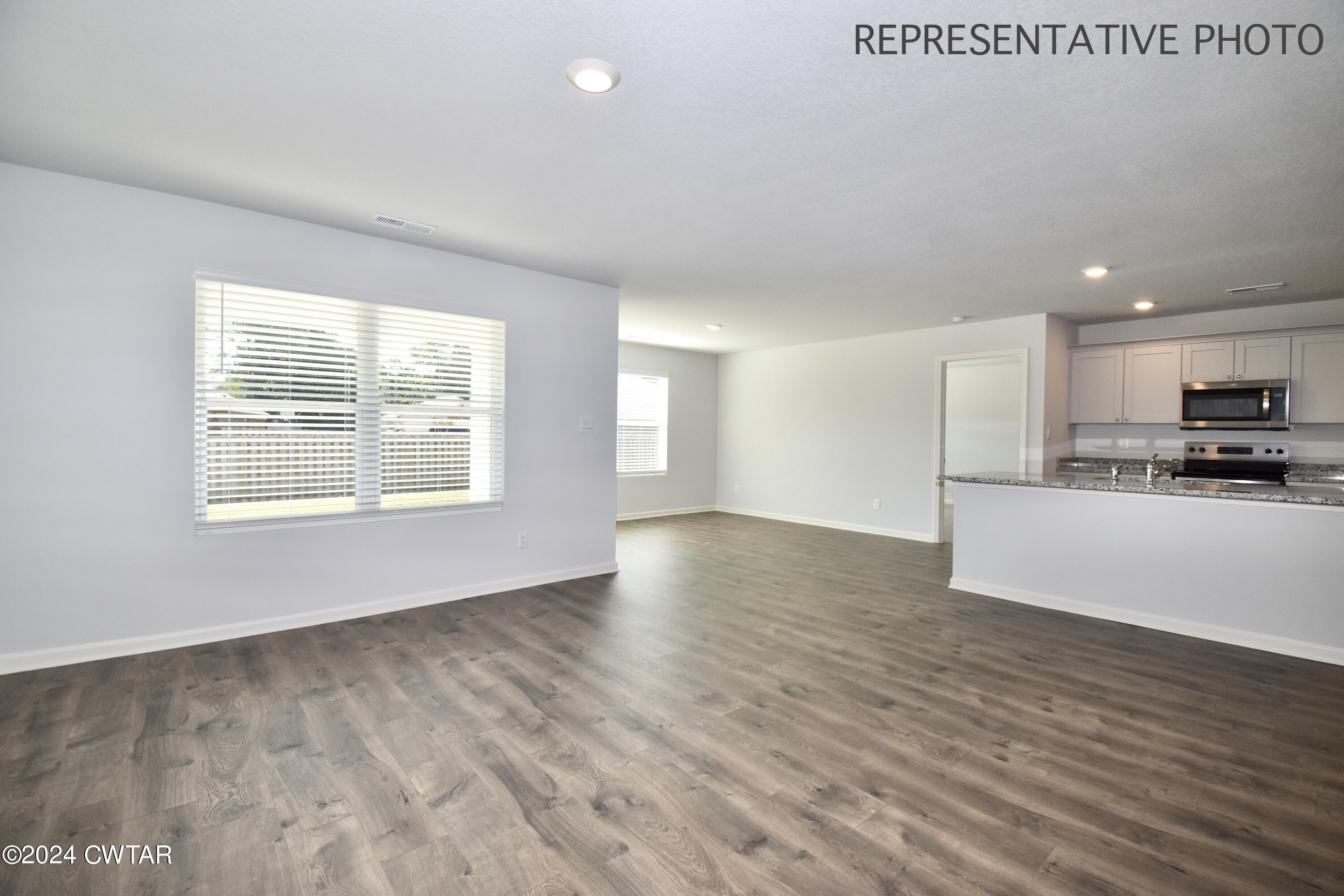 61 Vintage Grove Road Jackson, TN 38305 - Photo 11 of 25 a view of an empty room with wooden floor and a window