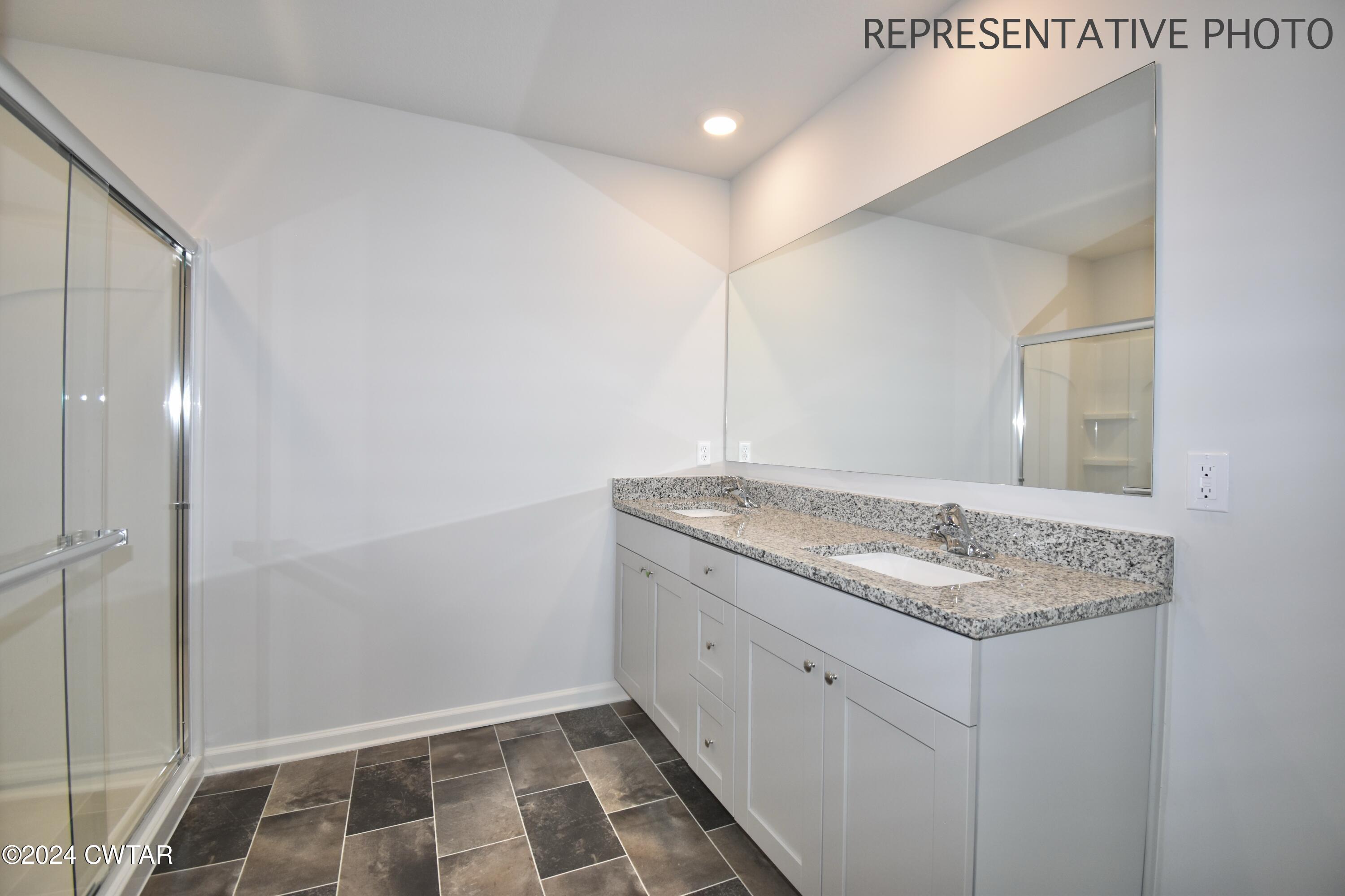 61 Vintage Grove Road Jackson, TN 38305 - Photo 18 of 25 a bathroom with a granite countertop sink and a mirror