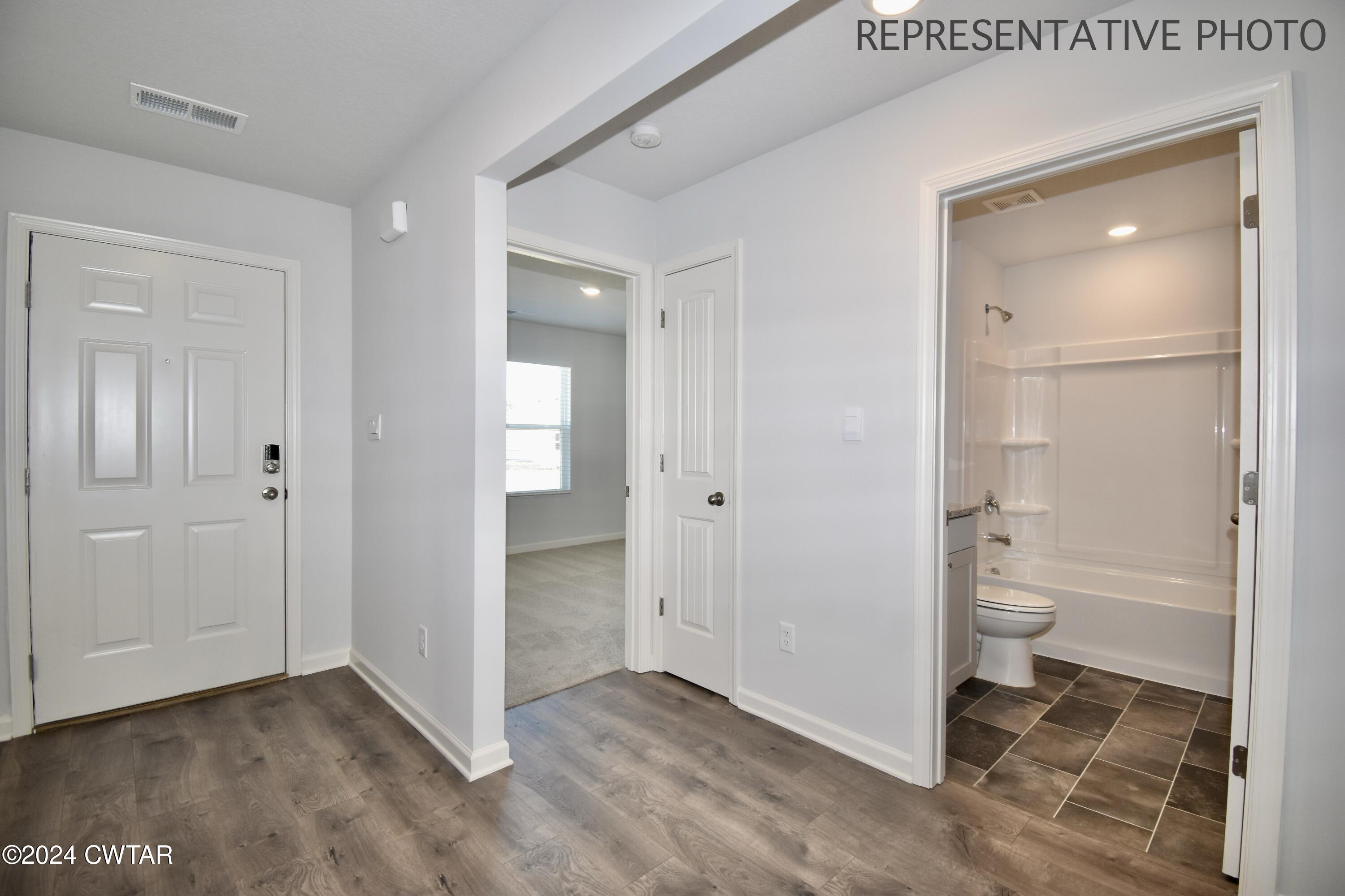 61 Vintage Grove Road Jackson, TN 38305 - Photo 20 of 25 wooden floor with closet and a mirror