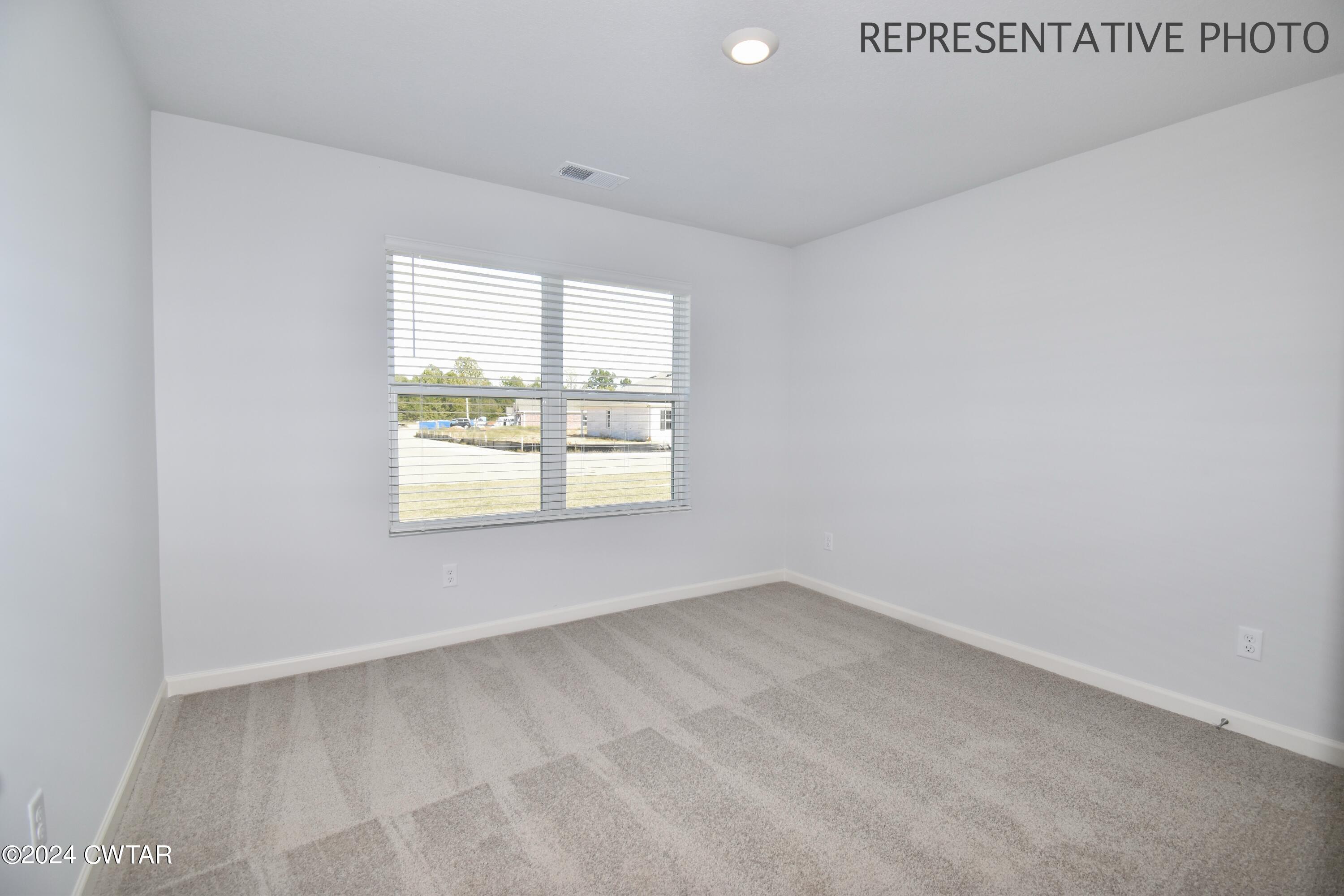61 Vintage Grove Road Jackson, TN 38305 - Photo 21 of 25 an empty room with a window