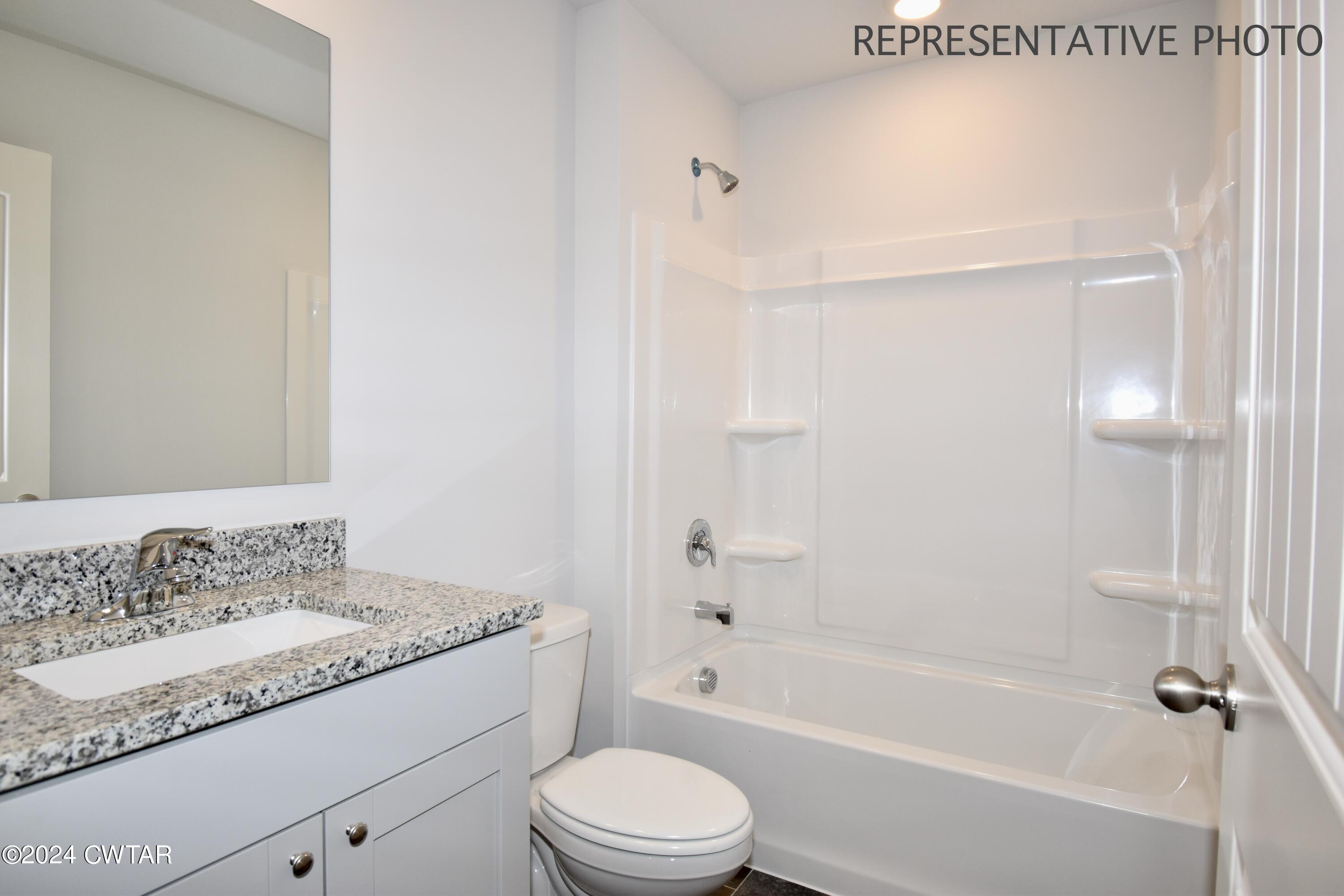 61 Vintage Grove Road Jackson, TN 38305 - Photo 22 of 25 a bathroom with a granite countertop sink toilet and shower