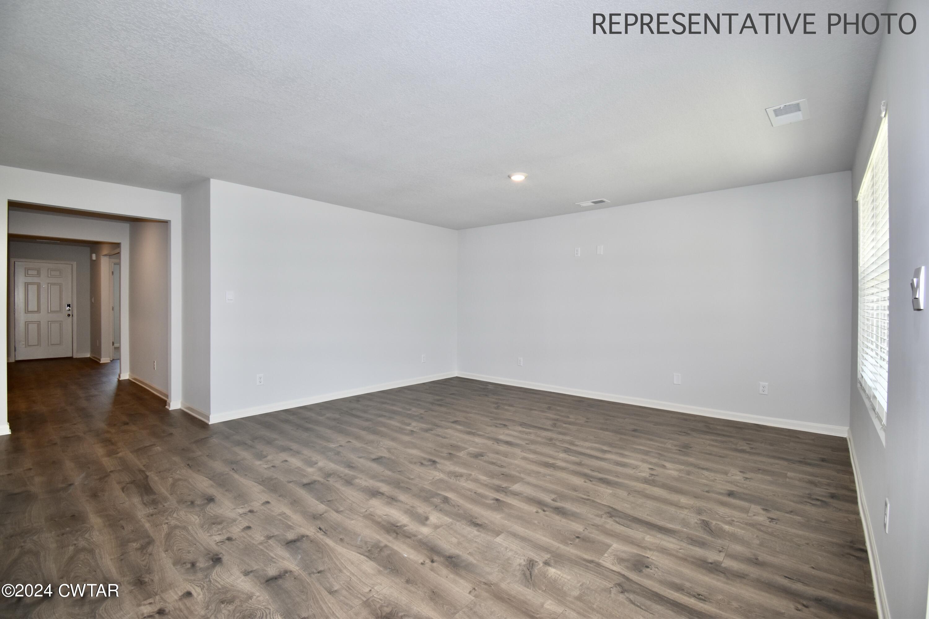 61 Vintage Grove Road Jackson, TN 38305 - Photo 5 of 25 a view of an empty room and wooden floor