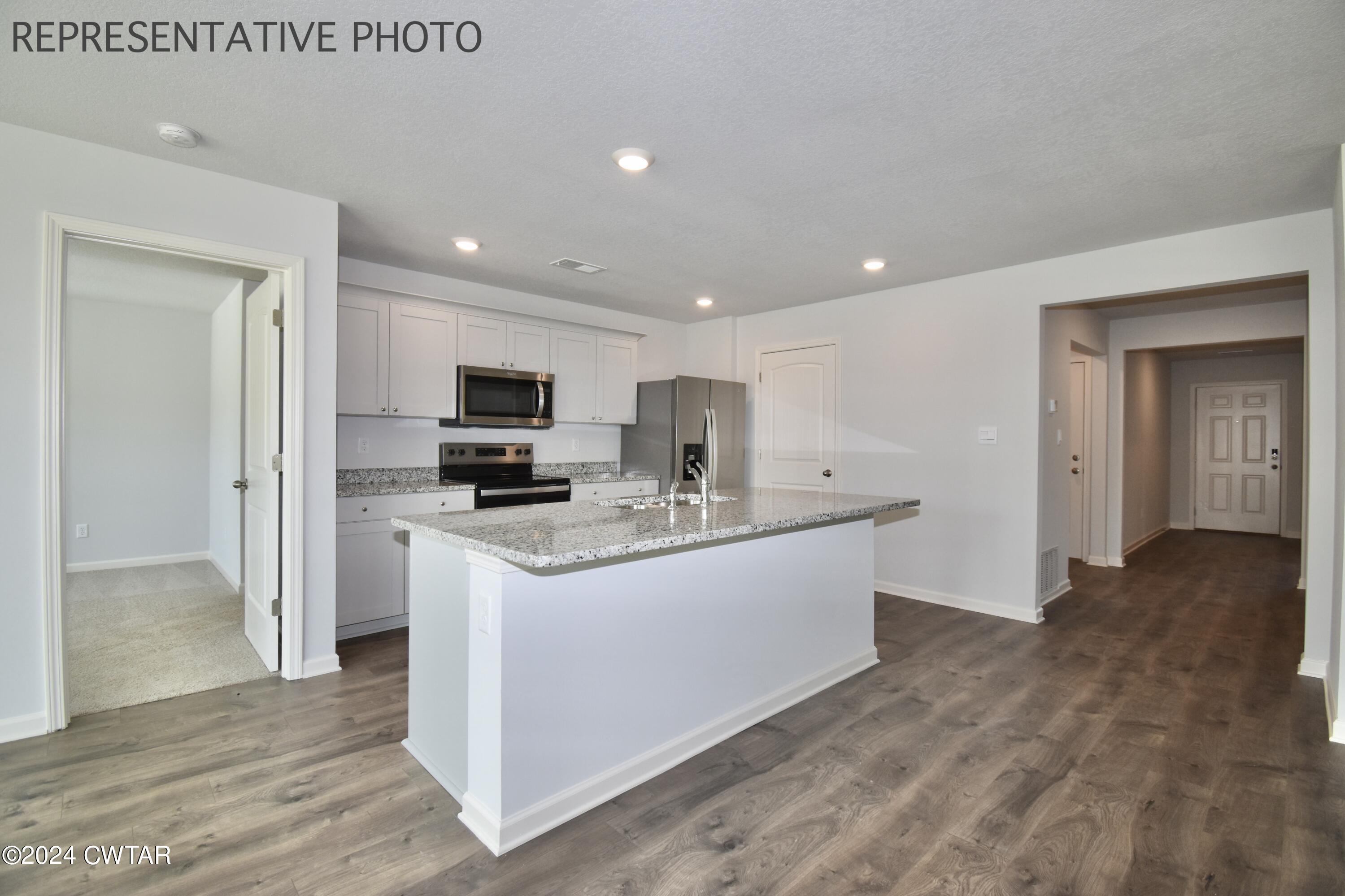 61 Vintage Grove Road Jackson, TN 38305 - Photo 6 of 25 a view of kitchen with stainless steel appliances granite countertop a stove a sink and a refrigerator