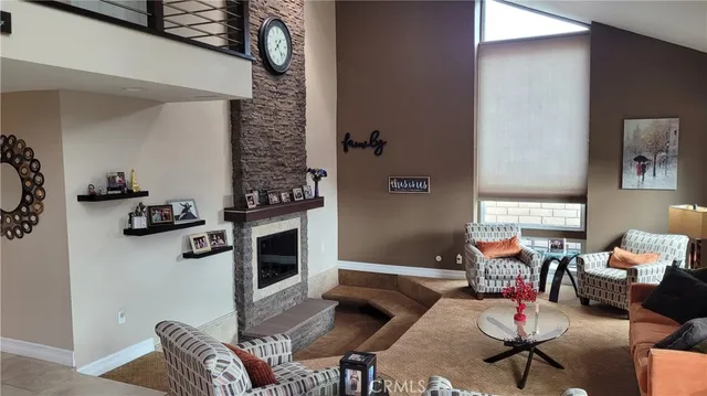 a living room with furniture a rug and a fireplace