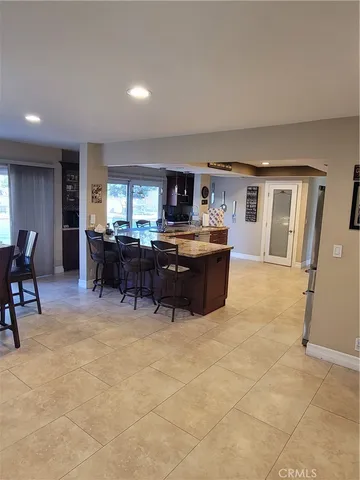 a living room with furniture and a kitchen